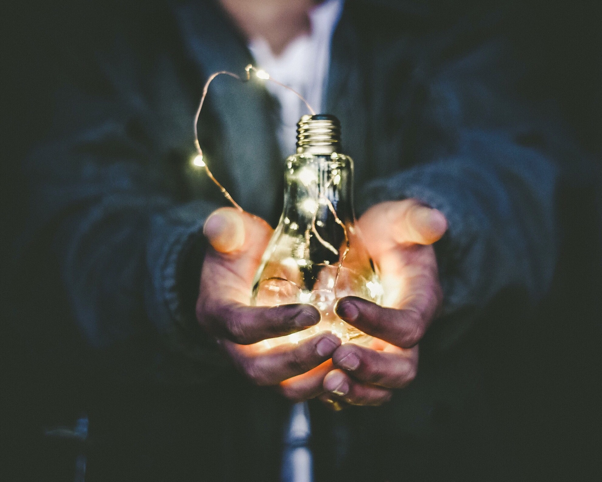 person holding a lightbulb