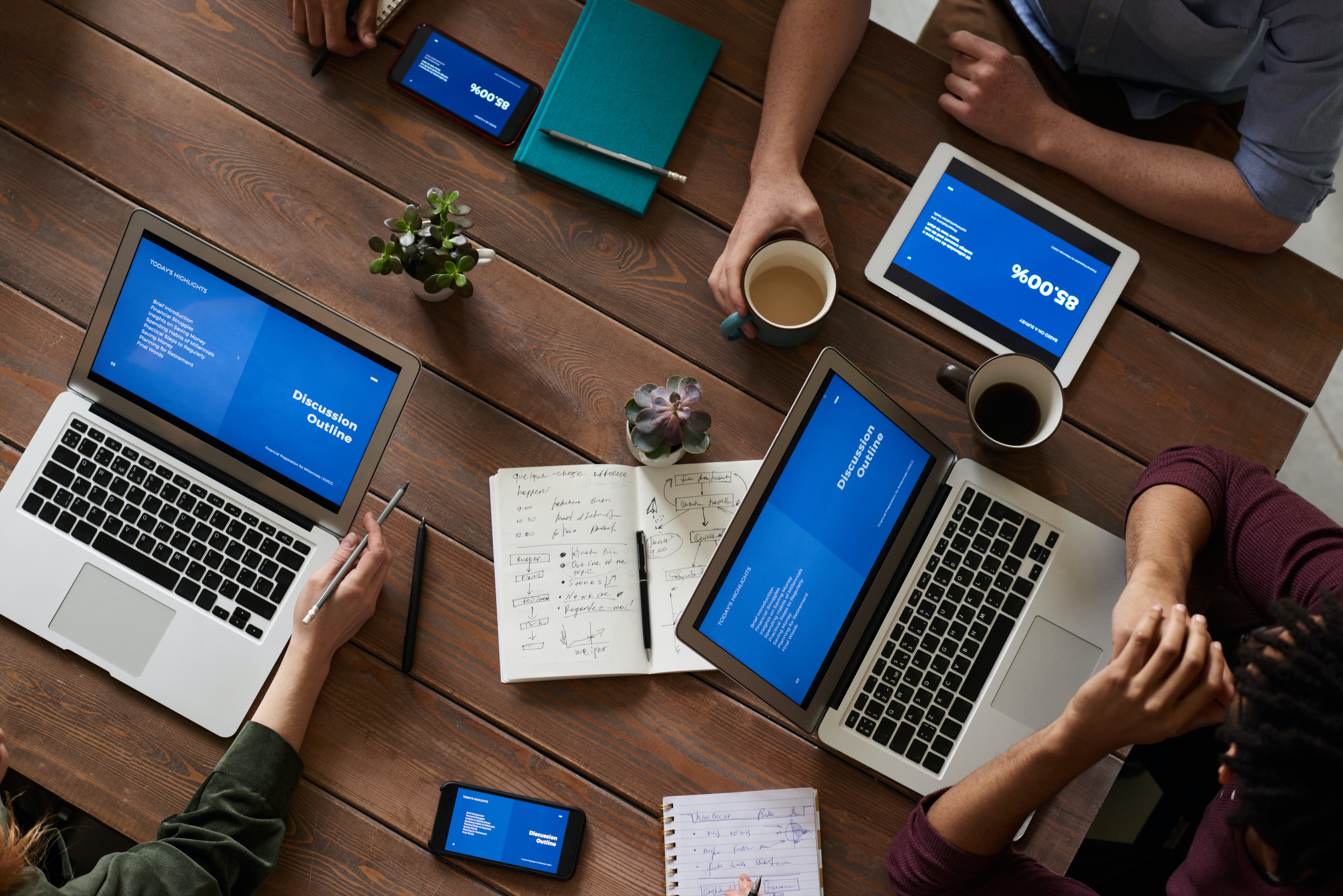 people with laptops at a table